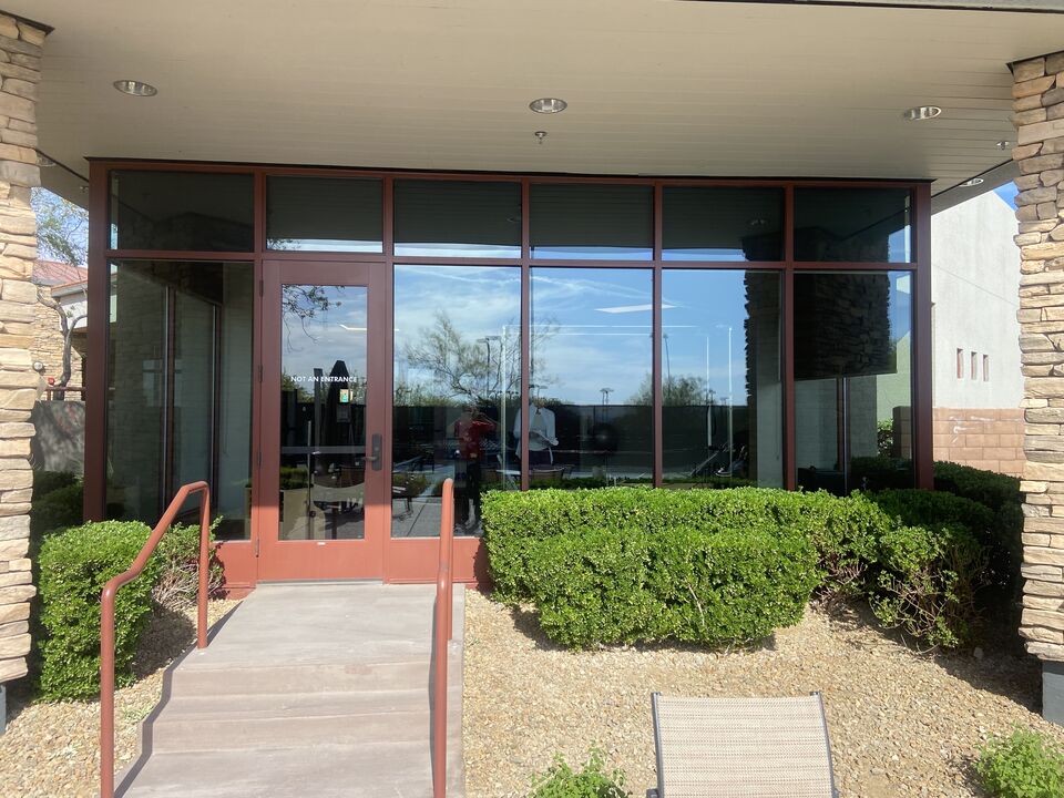 Clean storefront entry glass with a covered walkway